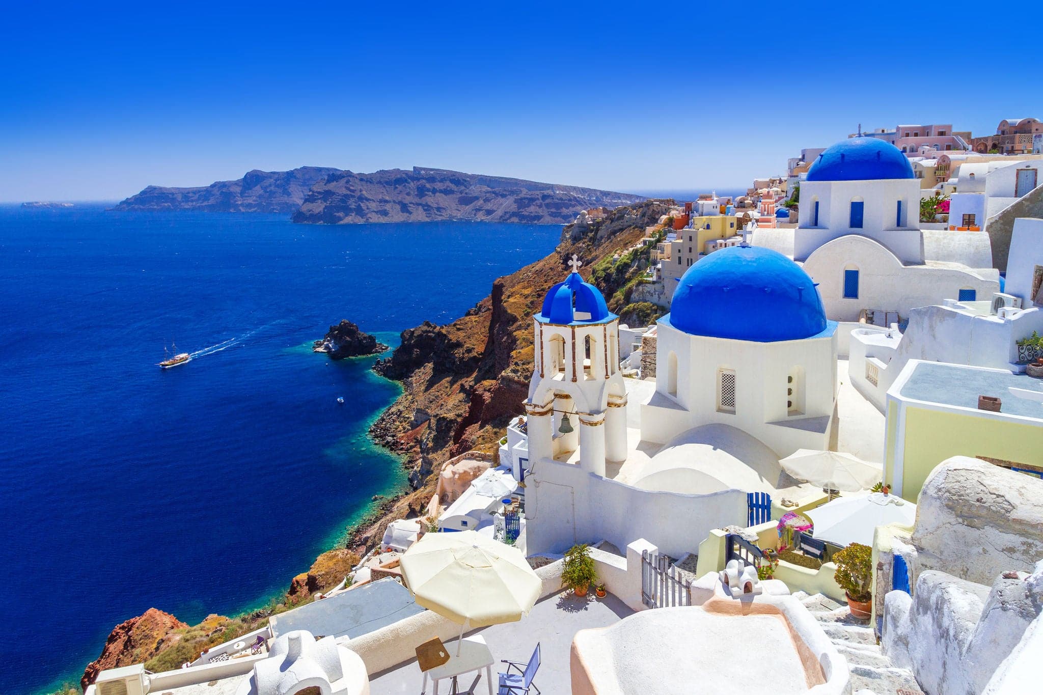 Cruise ship sailing near the Greek Isles with blue water and whitewashed villages